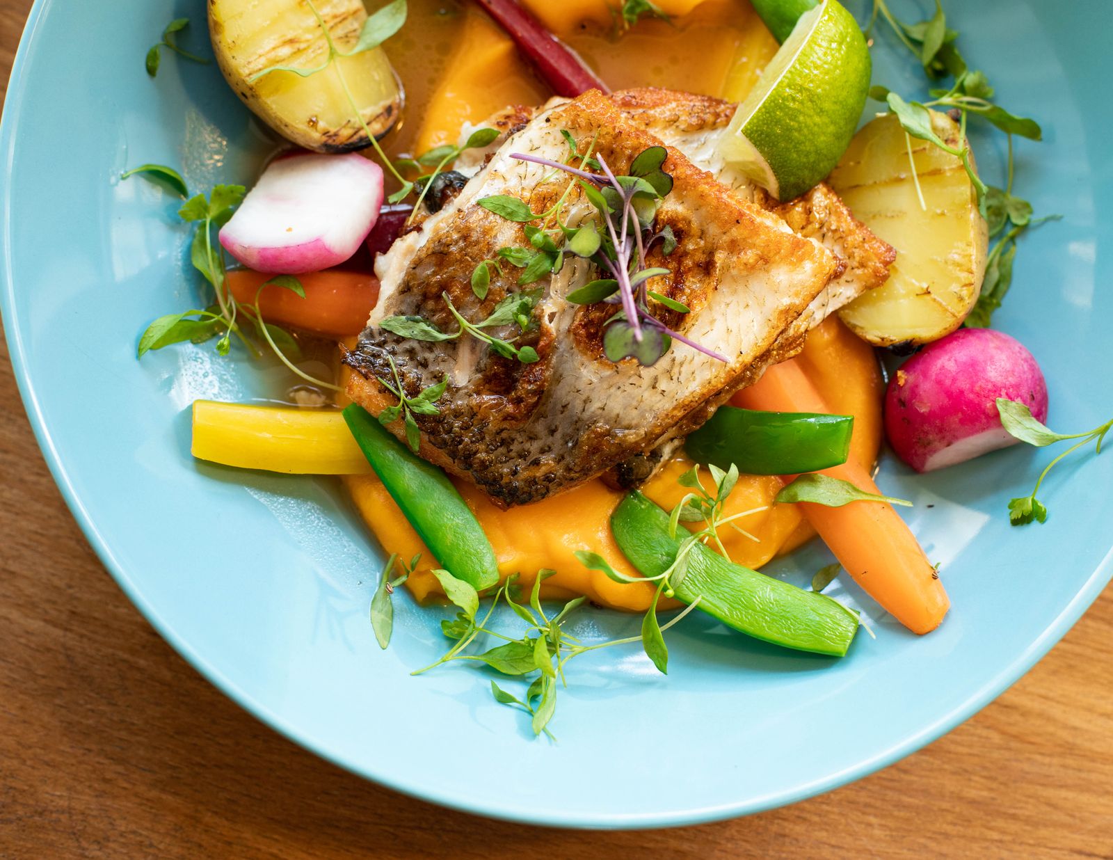 Colorful plate with grilled fish and vegetables